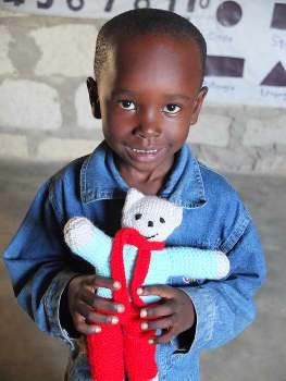 Photograph: A happy boy with his new teddy. 
